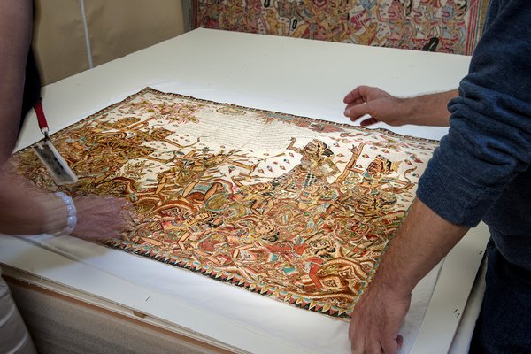 People looking at Balinese painting