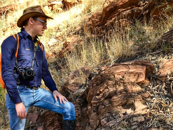 Dr Patrick Smith standing atop fossilised Early Cambrian (520 million year old) stromatolites at Ross River Gorge